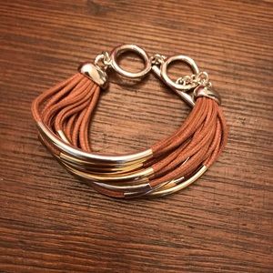 Tan and silver colored multi strand bracelet